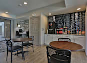 Thumbnail 18 of 38 - A kitchen with a table and chairs in front of a wall with a stone pattern.