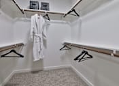 Thumbnail 10 of 38 - A white bathroom with a white robe hanging on a hanger.
