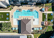 Thumbnail 26 of 32 - A swimming pool surrounded by a deck and a pavilion.
