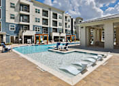 Thumbnail 17 of 32 - A large swimming pool in front of a building.