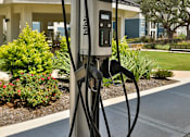 Thumbnail 28 of 32 - A Bilt car charging station is on the sidewalk.