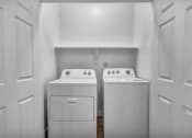 Thumbnail 6 of 32 - the laundry room of a home with two washes and a dryer