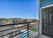 Thumbnail 7 of 32 - a balcony with a door and a view of a city
