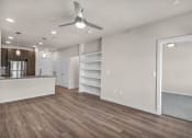 Thumbnail 10 of 32 - a living room with a kitchen and a ceiling fan