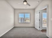 Thumbnail 12 of 32 - an empty bedroom with a ceiling fan and a window