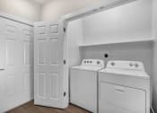 Thumbnail 15 of 32 - closet with white washer and dryer and white doors