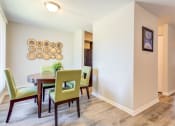 Thumbnail 20 of 46 - a dining room with a table and chairs
