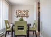 Thumbnail 19 of 46 - a dining room with a table and chairs