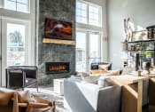 Thumbnail 13 of 30 - a living room with a couch and a fireplace