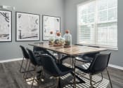 Thumbnail 16 of 30 - a dining room with a wooden table and black chairs
