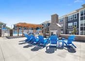 Thumbnail 24 of 30 - our apartments have a large patio with blue chairs and a fire pit