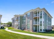 Thumbnail 29 of 30 - an exterior view of an apartment building with a sidewalk