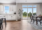 Thumbnail 4 of 30 - a kitchen and dining room with a large window and a door to a balcony
