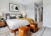 Thumbnail 6 of 30 - a bedroom with a bed and a chair and a closet