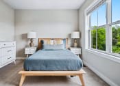 Thumbnail 7 of 30 - a bedroom with a bed and two large windows