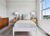 Thumbnail 8 of 30 - a bedroom with a bed and two windows
