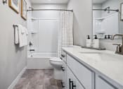 Thumbnail 10 of 30 - a bathroom with a sink and a toilet and a shower