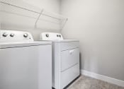 Thumbnail 13 of 30 - the laundry room has a washer and dryer and a shelf above the door