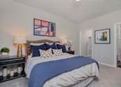 Thumbnail 9 of 43 - A bedroom with a large bed and a painting on the wall.