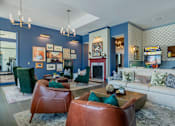 Thumbnail 18 of 43 - A living room with a fireplace and a couch.