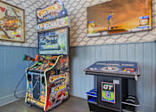 Thumbnail 30 of 43 - A small arcade room with a Big Buck Hunter machine and a smaller GT machine.