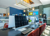 Thumbnail 23 of 43 - A modern home office with a large desk and a computer setup.
