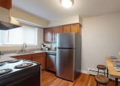 Thumbnail 12 of 34 - a kitchen with stainless steel appliances and a wooden table