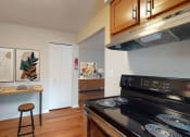 Thumbnail 13 of 34 - a kitchen with a stove and a counter with stools