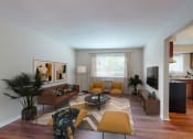 Thumbnail 14 of 34 - a living room with a couch and a table