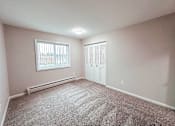 Thumbnail 5 of 34 - A room with a window and a carpeted floor.
