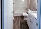 Thumbnail 8 of 34 - A small bathroom with a toilet, sink and shower.