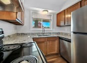 Thumbnail 11 of 34 - a kitchen with stainless steel appliances and granite counter tops
