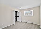 Thumbnail 21 of 34 - an empty room with white walls and a window and a closet