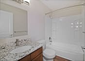 Thumbnail 23 of 34 - a bathroom with a sink and a shower and a toilet