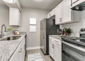 Thumbnail 1 of 30 - an updated kitchen with granite counter tops and stainless steel appliances