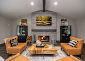 Thumbnail 25 of 30 - A modern living room with a fireplace and two chairs.