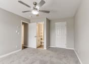 Thumbnail 6 of 30 - an empty living room with a ceiling fan and a closet