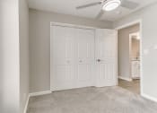 Thumbnail 8 of 30 - an empty bedroom with two closets and a ceiling fan