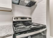 Thumbnail 9 of 30 - a kitchen with a stove and a counter top