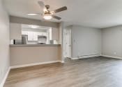 Thumbnail 16 of 30 - an empty living room and kitchen with a ceiling fan