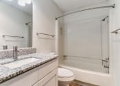 Thumbnail 15 of 30 - a bathroom with a sink and a shower and a toilet