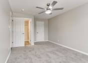 Thumbnail 19 of 30 - an empty living room with a ceiling fan