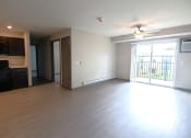 Thumbnail 13 of 30 - an empty living room with wood flooring and a balcony
