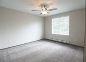 Thumbnail 21 of 30 - an empty room with a ceiling fan and a window