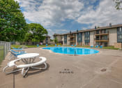 Thumbnail 29 of 30 - our apartments have a resort style pool with chairs and tables