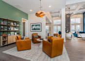 Thumbnail 19 of 30 - clubhouse with brown leather chairs and shelves