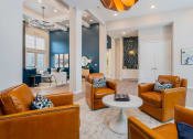 Thumbnail 20 of 30 - apartment community clubhouse with brown leather chairs and round coffee table