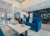 Thumbnail 17 of 30 - community clubhouse with blue sofas and large coffee table
