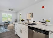Thumbnail 4 of 30 - a kitchen with a counter top and a dishwasher in a living room