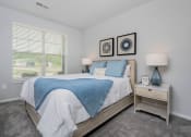 Thumbnail 7 of 30 - a bedroom with a bed and a window
